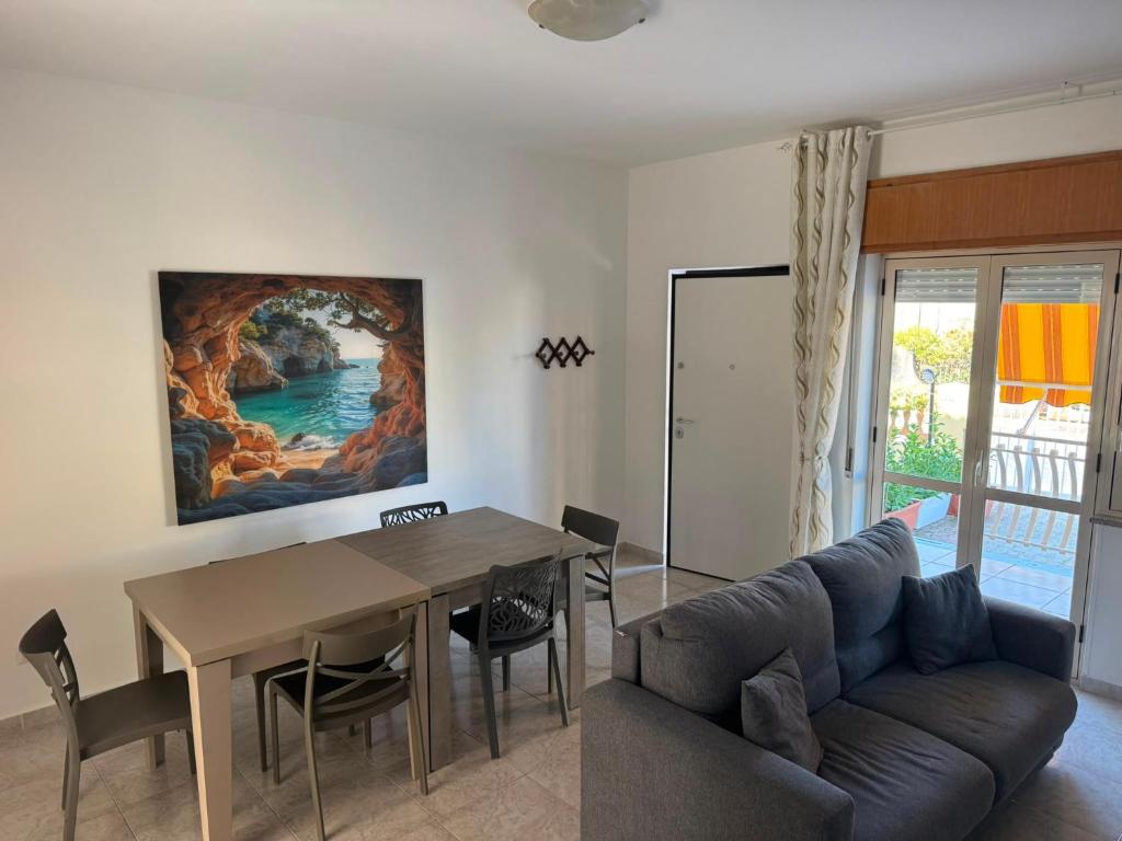 a living room with a table and a couch at DE ROSA'S home 4 in Praia a Mare