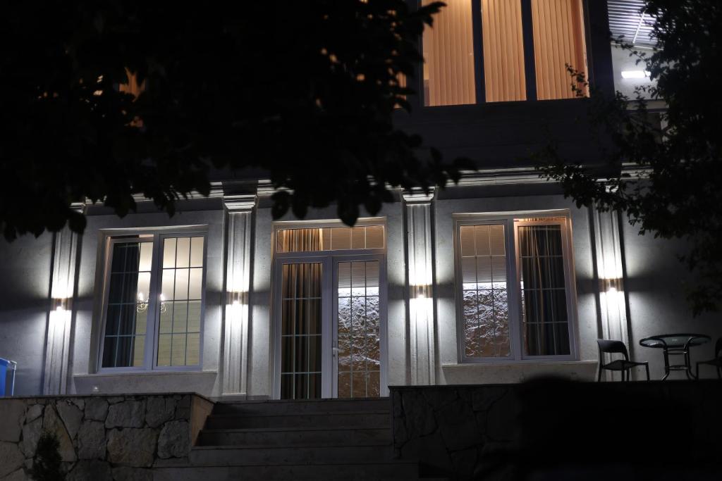 a house with lights on the front of it at night at Sunny Home in Ijevan