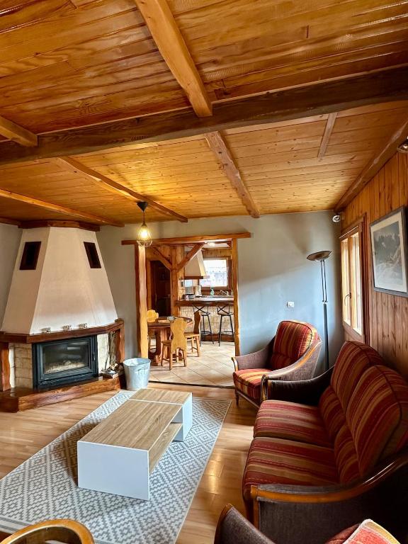a living room with a couch and a fireplace at Appartement L'argentiere la bessée in LʼArgentière-la-Bessée