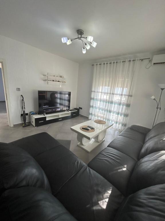 a living room with a leather couch and a table at Apartment Petar in Kotor