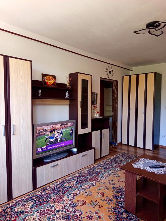 a living room with a flat screen tv on a wall at Modern Beach Apartment in Constanţa