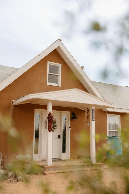 a small house with a wreath on the door at El Ranchito Alegre Private 3BR Home in Historic Corrales in Corrales