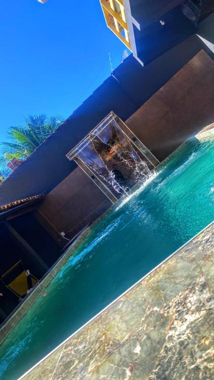 a glass table sitting on top of a body of water at Panorâmic Luxo Exclusiv in Santa Cruz Cabrália