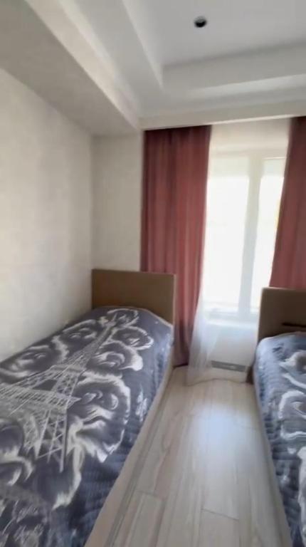 a bedroom with a bed with a dragon blanket at Novel in Korumdy