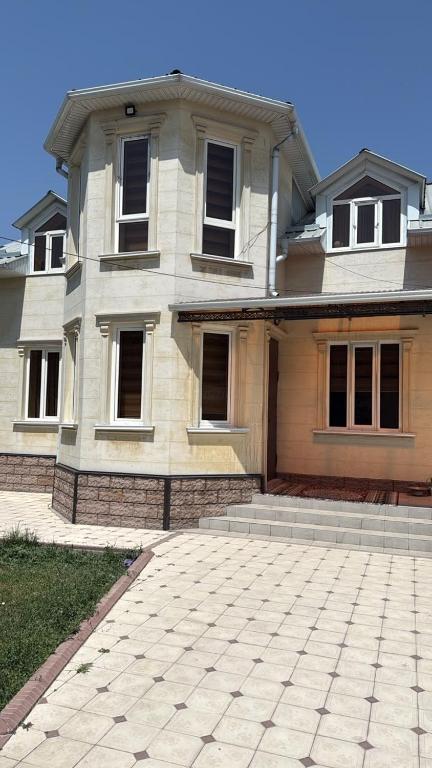 a large house with a driveway in front of it at Family Villa in Osh