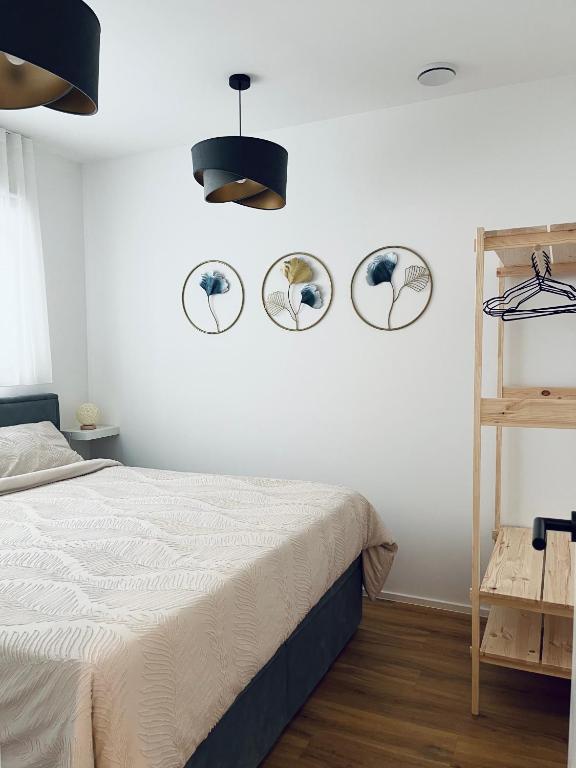 a bedroom with a bed and three mirrors on the wall at Bubbly Apartment in Bled
