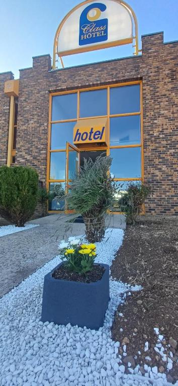 a hotel with flowers in front of a building at Class-Hôtel in Poitiers
