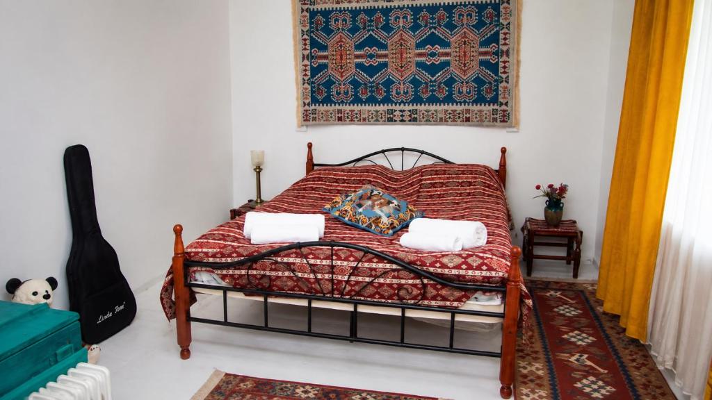 a bedroom with a bed with a red blanket at Guest House in Sanahin in Sanain