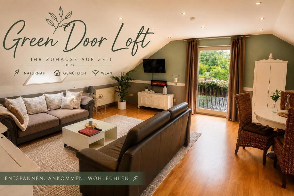 a living room with a couch and a table at Green Door Loft Stilvolles 160 m2 Apartment Balkon Gartenblick Workstation Hundefreundlich in Ibbenbüren