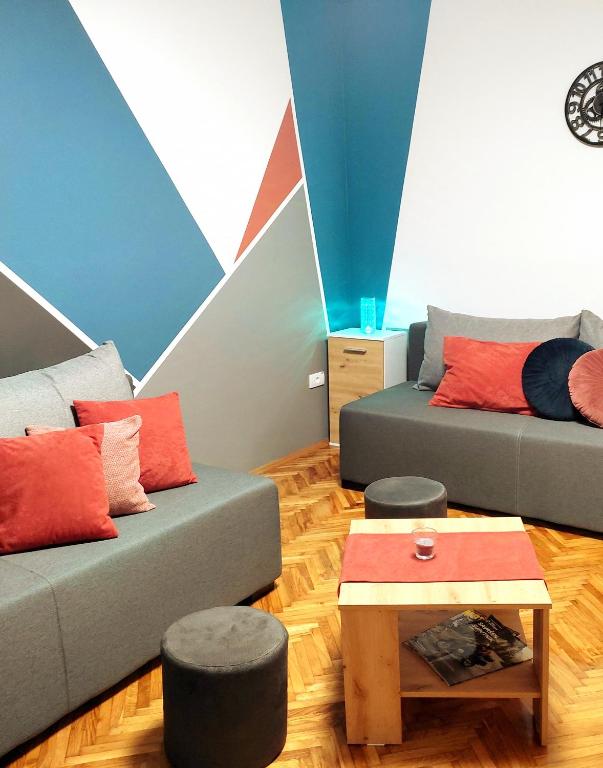 a living room with two couches and a coffee table at Ravena in Palić