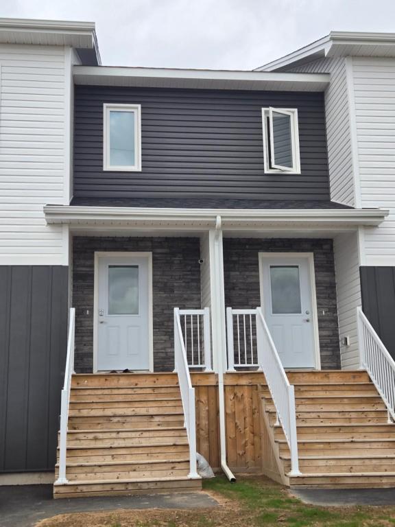 a house with a wooden staircase in front of it at Private Guest Suite Sleeps 4 in Riverview