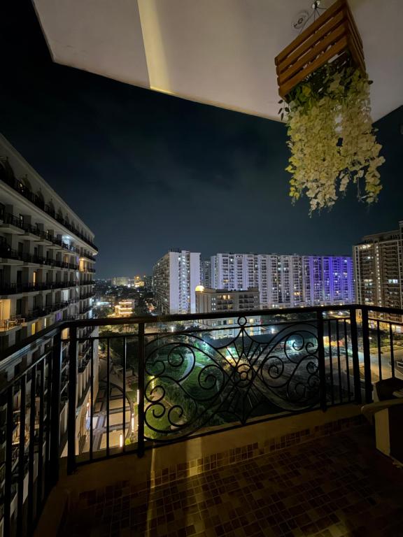 a balcony with a view of a city at night at Aureva stays Omaxe Hazratganj in Nalmatha
