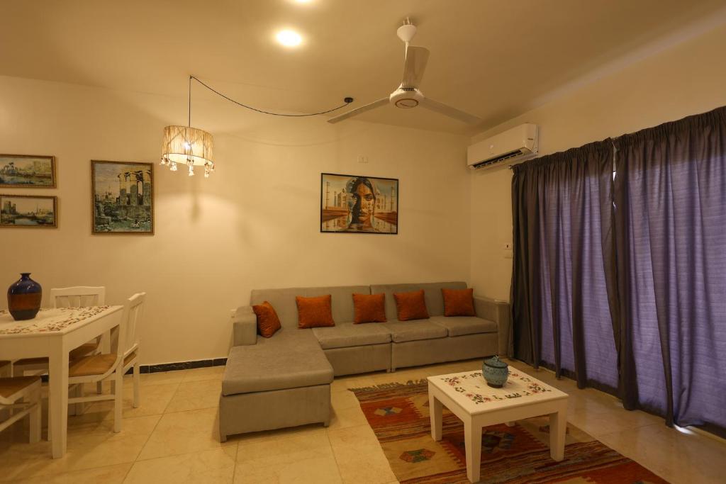 a living room with a couch and a table at calming valley in Luxor