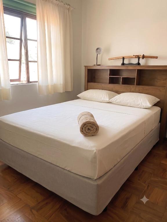 a large bed in a bedroom with a wooden floor at Sobrado Jardim Itália in Itapetininga