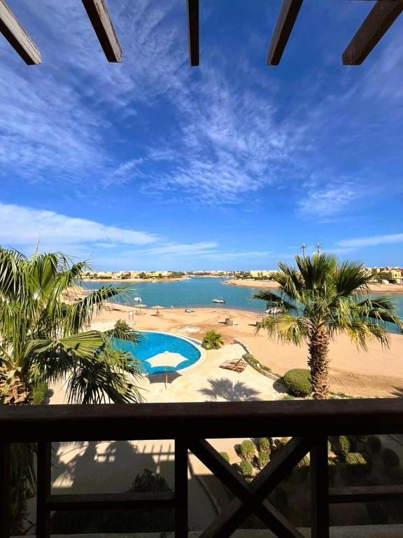 a view from the balcony of a resort with a swimming pool at Sabina 2BD with pool and lagoon view in Hurghada