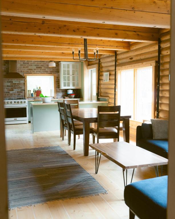 a kitchen and dining room with a table and chairs at Little Atlin Lodge in Tagish