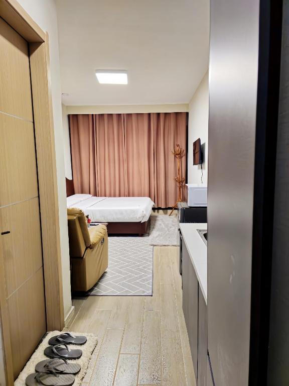 a hotel room with a bedroom with a bed and a couch at JKIA Transit Hub in Syokimau