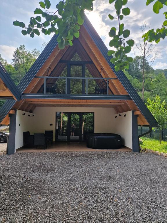a house with a gambrel roof with a living room at River Zen House in Šipovo
