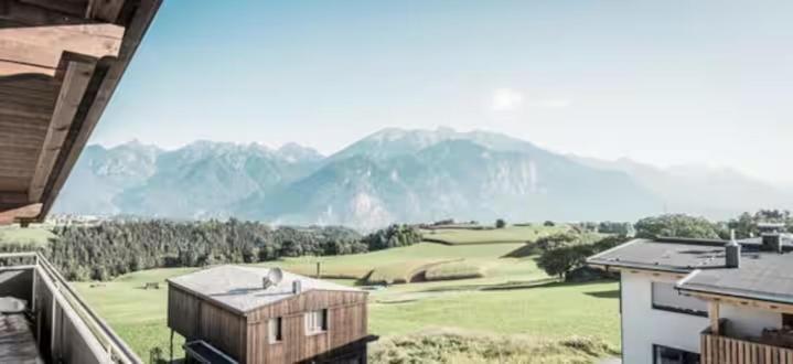 a view of a golf course with mountains in the background at Tyrolhaus in Grinzens