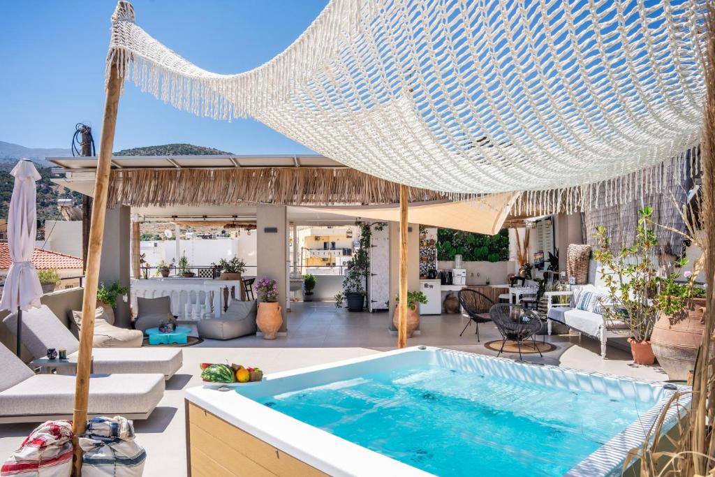 a villa with a swimming pool and a patio at Malia Boutique Studios in Malia