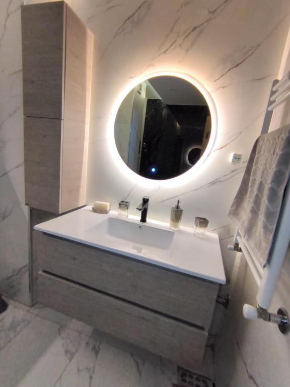 a bathroom with a sink and a mirror at Nassim19 in Sétif