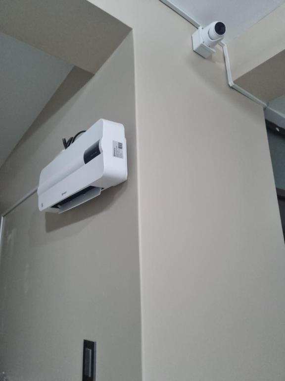 a printer on the wall of a room at Misky Samana Hotel in Espinar
