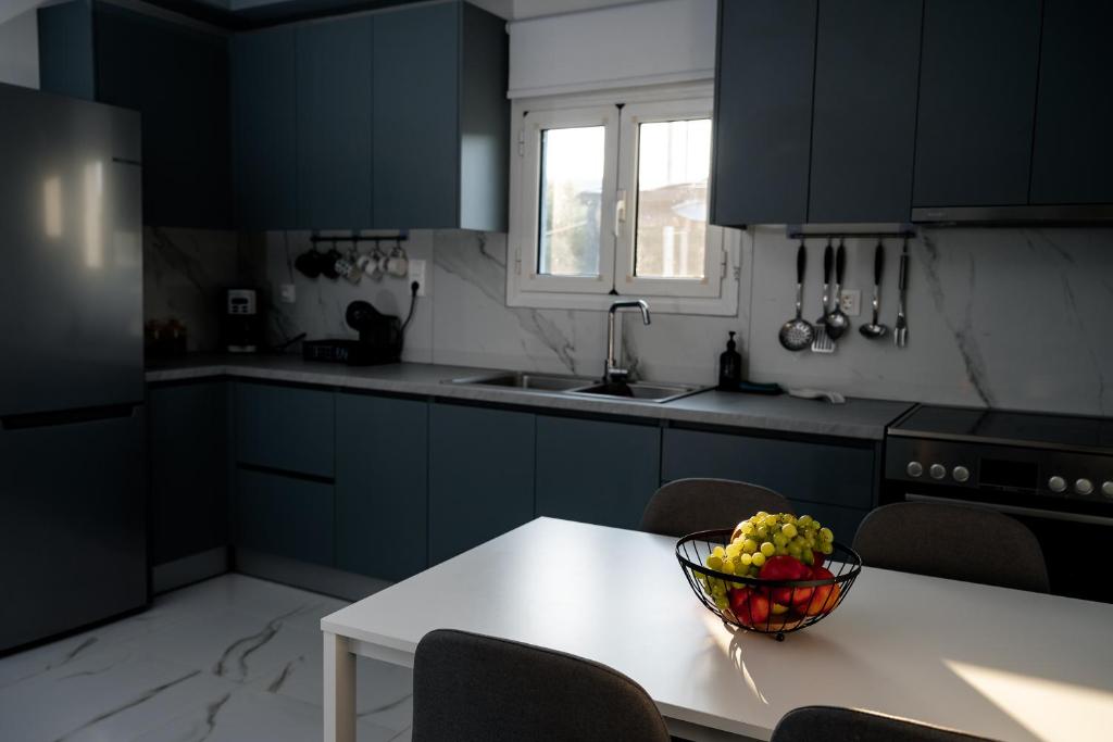 a kitchen with a bowl of fruit on a table at Angels luxury villa in Kastamonítsa