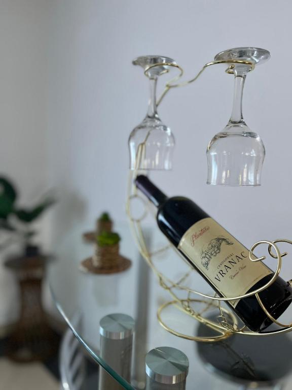 a bottle of wine in a wine glass holder at Studio apartman Delic in Podgorica