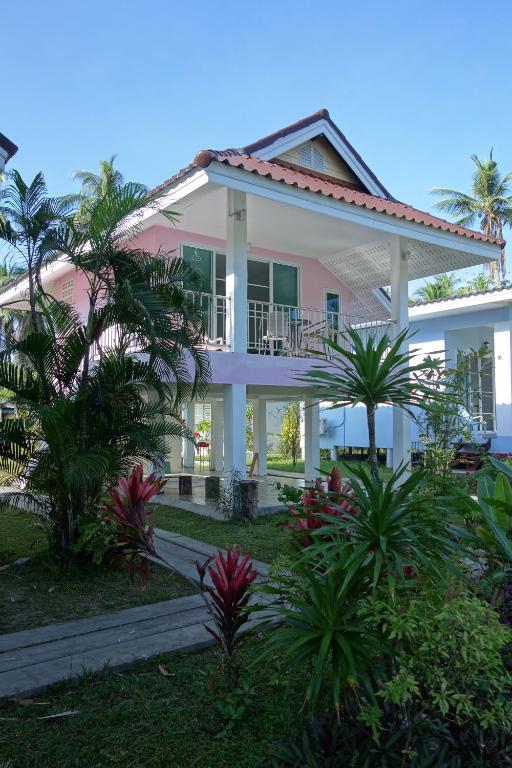 a house with palm trees in front of it at Mook Ing Lay in Ko Mook