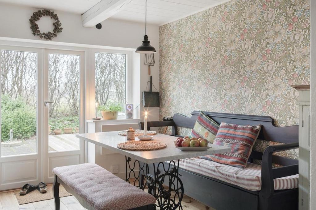 a living room with a table and a couch at Pärla in Kåseberga in Löderup