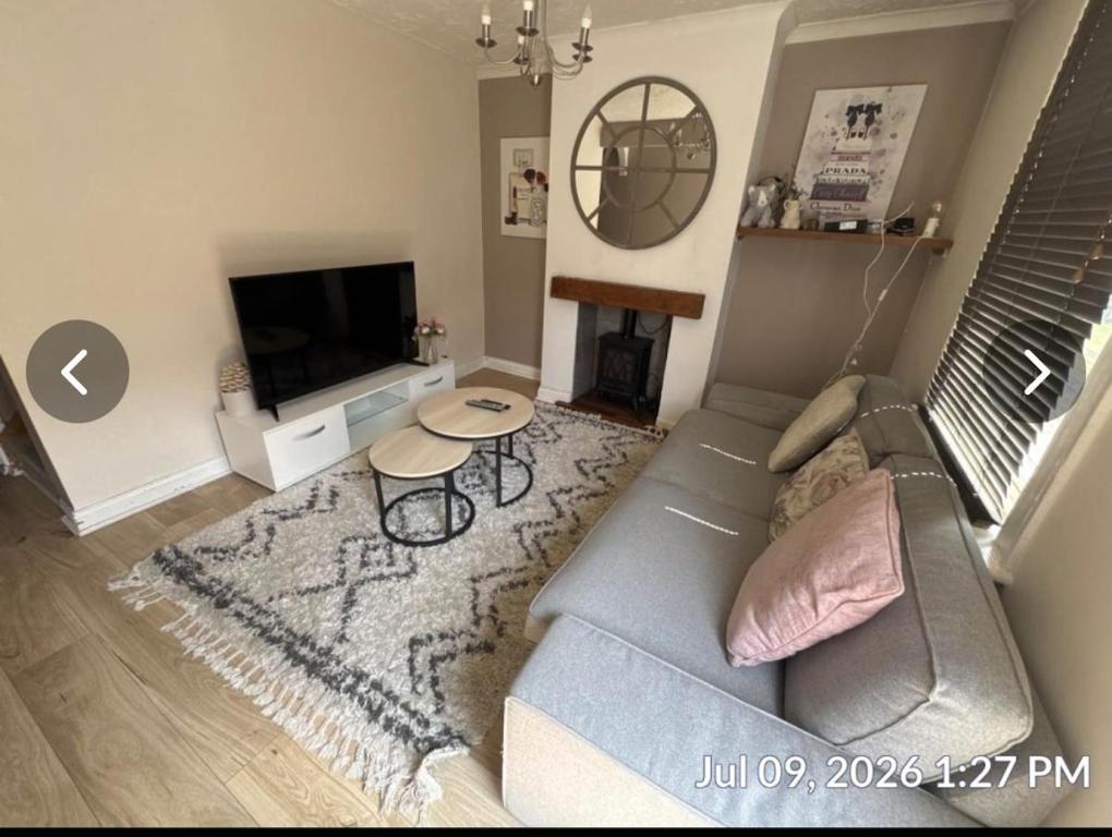 a living room with a couch and a table at Luxurious Modern Town House in Gillingham