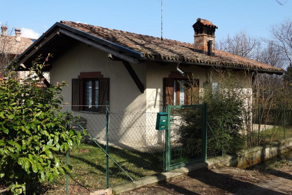 a small house with a fence in front of it at La Casetta in Dronero