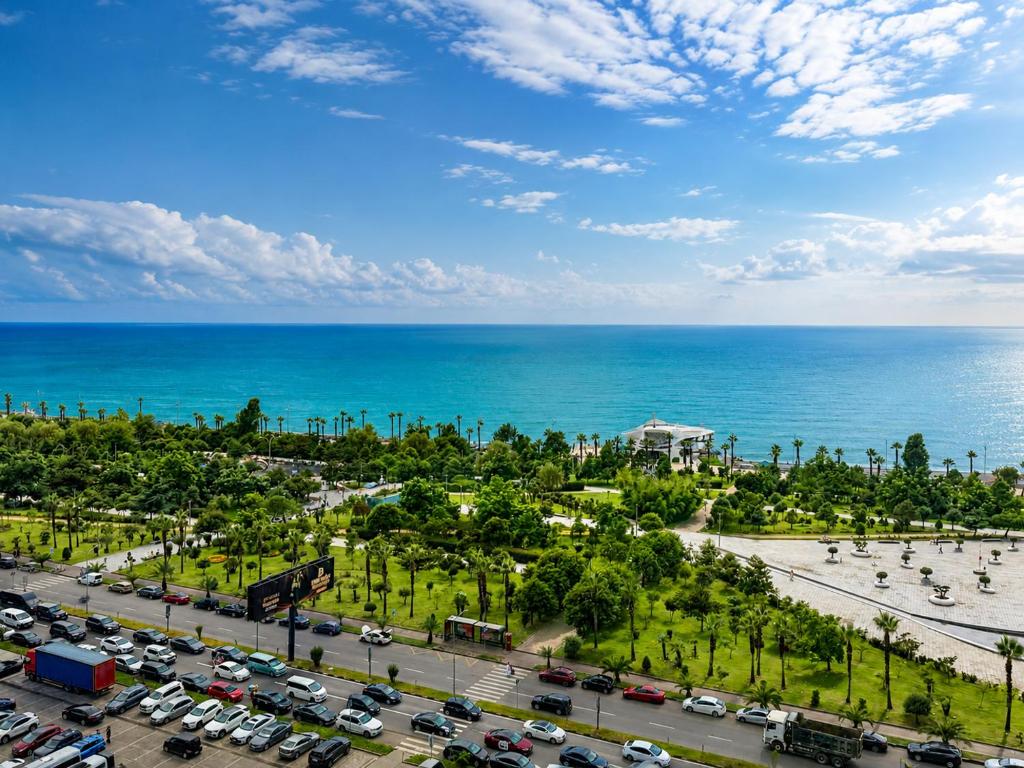 an aerial view of a parking lot with the ocean at Batumi - Seaside Stunning Apartment in Batumi