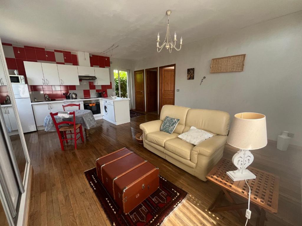 a living room with a couch and a table at La Maison d Ingrandes - relais Valami in Ingrandes-de-Touraine