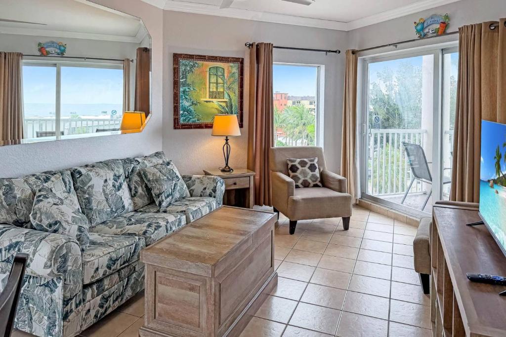 a living room with a couch and a table at 501-S - Sunset Vistas in St. Pete Beach