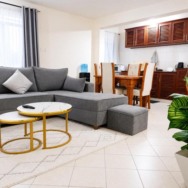 a living room with a couch and a table at 1 bedroom apartment in shanzu near pride inn resort in Mombasa