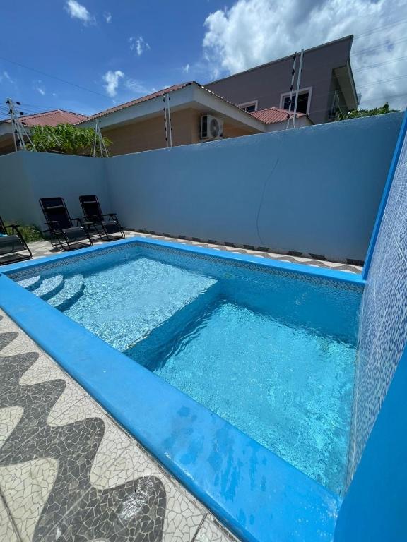 a blue swimming pool with a fence around it at Casa villeda in La Ceiba