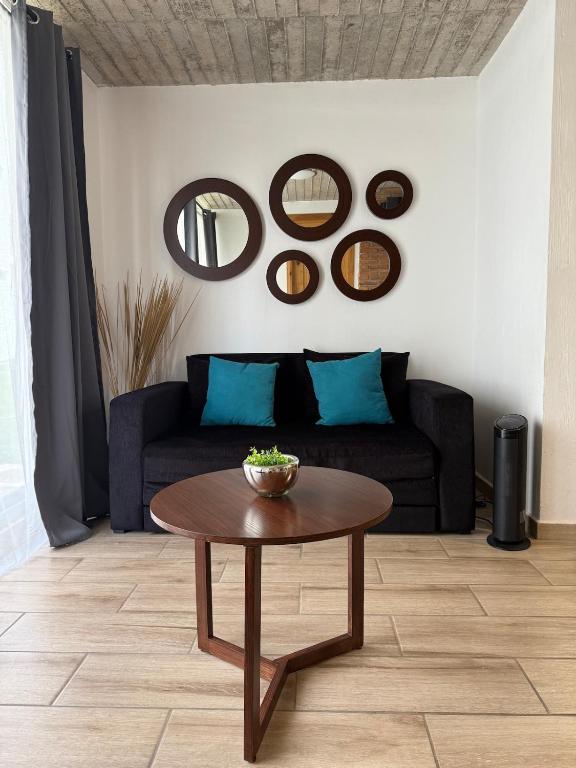 a living room with a couch and a table at Lovely chalet in Mazamitla in Puente de las Cuevas
