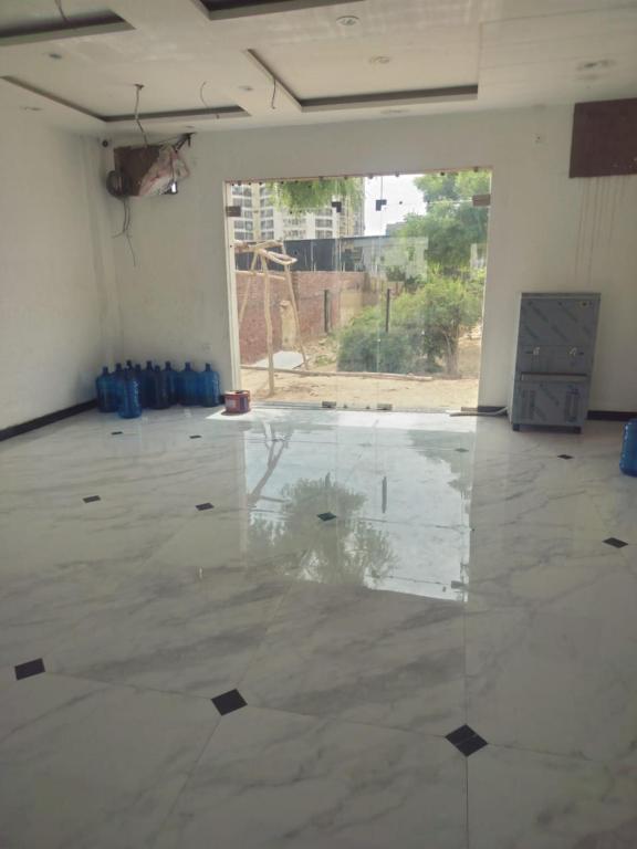 an empty room with a large window and a concrete floor at Hotel New Imperial inn in Chhatikara