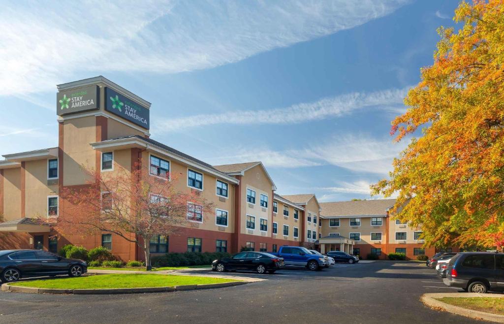 a hotel with cars parked in a parking lot at Extended Stay America Suites - Hartford - Meriden in Meriden
