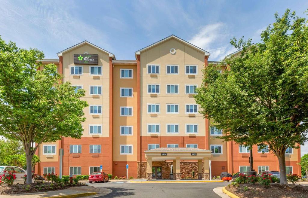 an image of a hotel with trees in front of it at Extended Stay America Suites - Washington, DC - Centreville - Manassas in Centreville