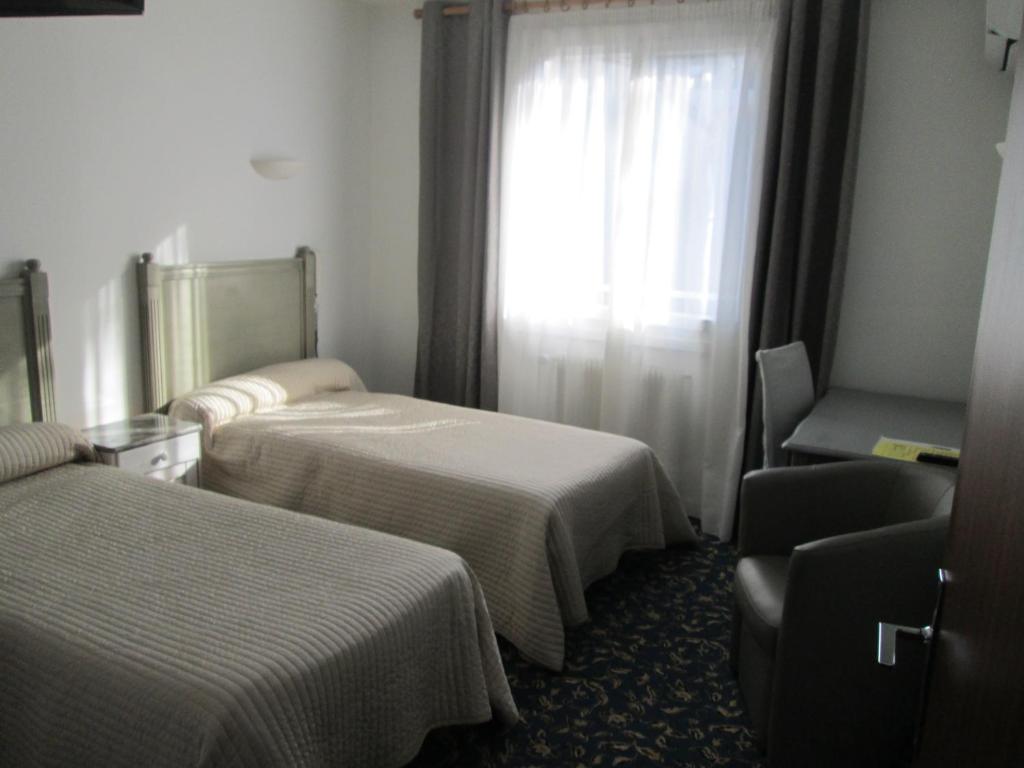 Postel nebo postele na pokoji v ubytování Hotel Victor Hugo