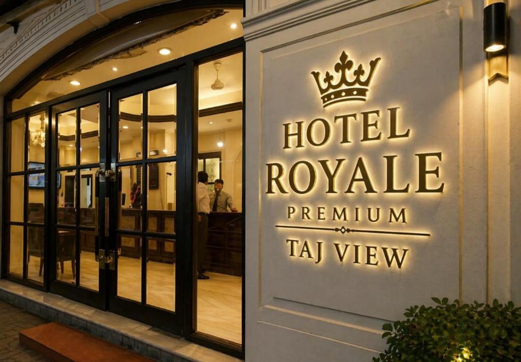 a hotel royale sign on the side of a building at Hotel New Aroma inn in Tājganj