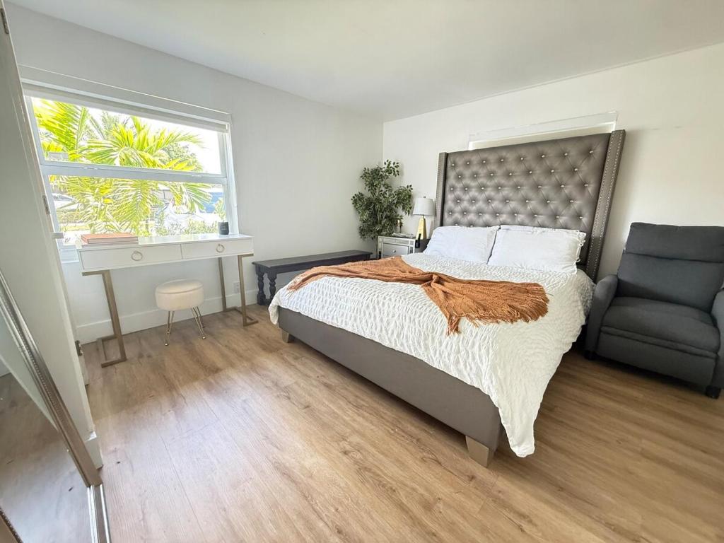 a bedroom with a bed and a couch and a window at Private Suite with Laundry in Sunset