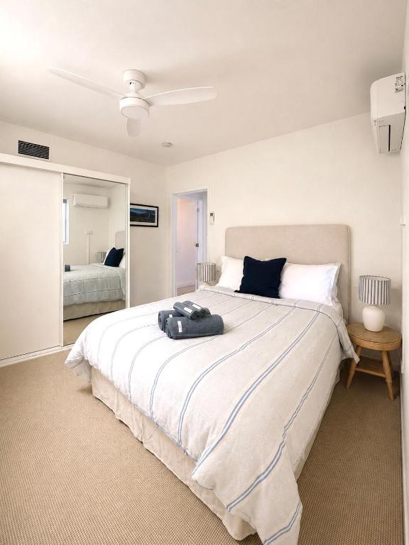 a bedroom with a large bed and a mirror at 'The Station House' Mount Isa in Mount Isa