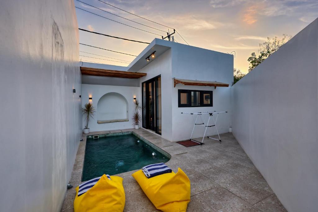a swimming pool in the backyard of a house at Villa Astella in Nusa Penida