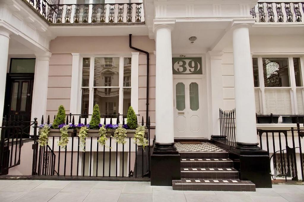 a white house with a front door with a gate at 39 Studios in London
