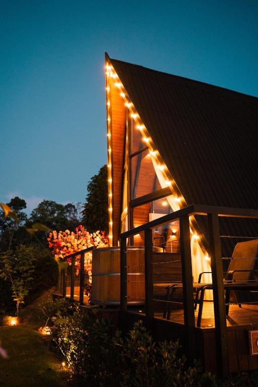 a house with lights on the side of it at night at Cabana Veneza in Santa Teresa