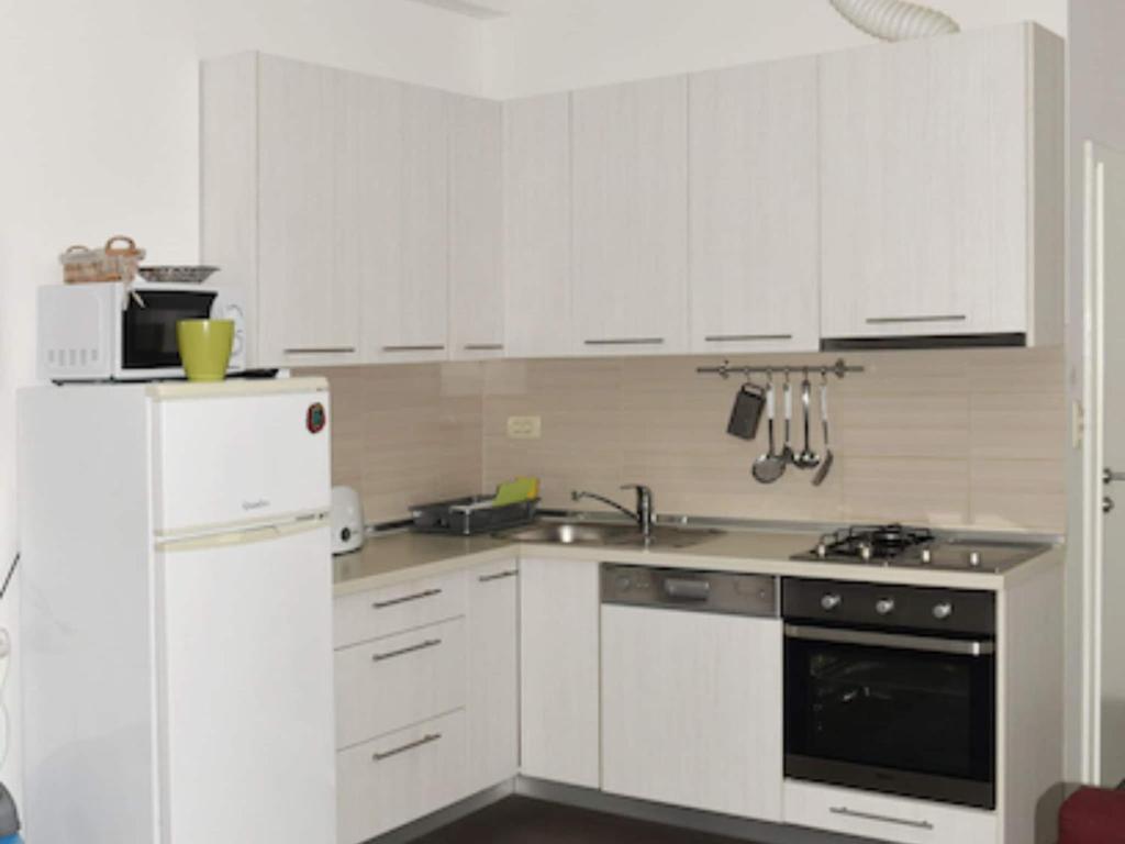 a kitchen with white cabinets and a white refrigerator at Apartments Despot Zaostrog RC in Zaostrog
