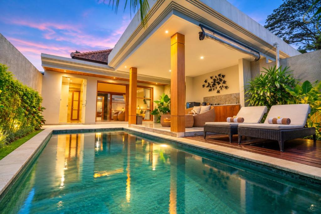 a swimming pool in the backyard of a villa at Arta Private Villa in Ubud